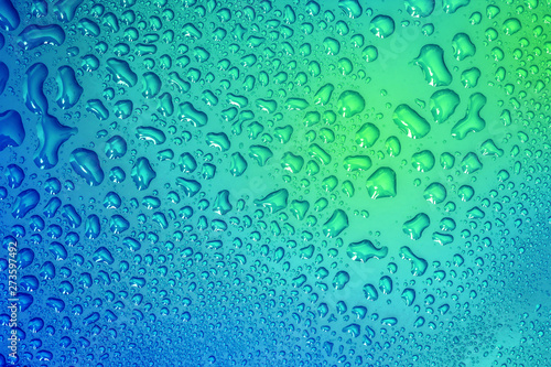 The Abstract water drop on surface of  fresh blue background