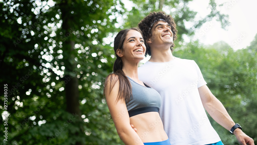 Happy couple running and jogging together outdoor Happy couple running and jogging together outdoor