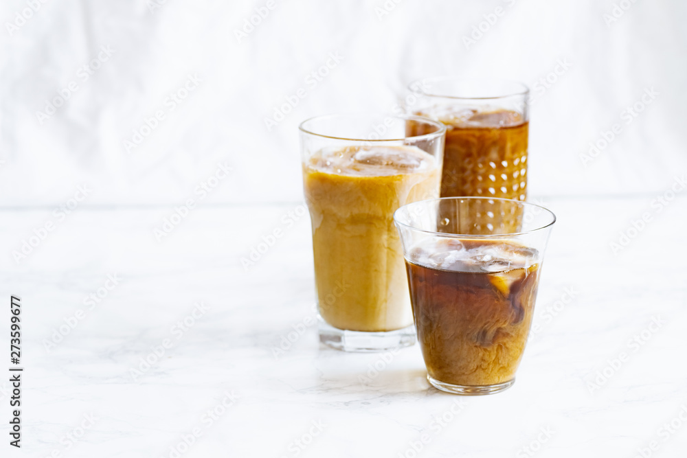 Iced coffee with cream and vanilla in various glasses on white background. Summer cocktail or dessert Iced coffee with cream and vanilla in various glasses on white background. Summer cocktail or dessert