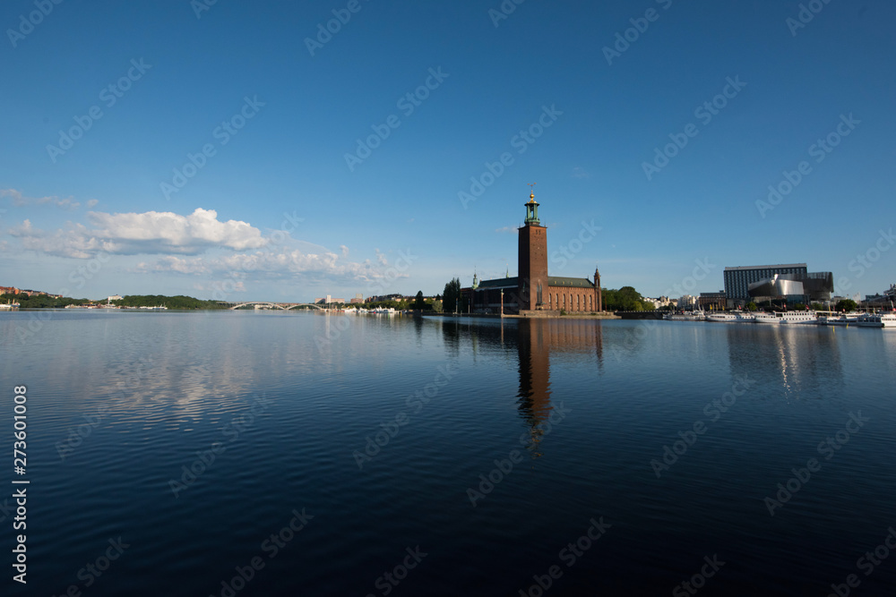 Town City hall, boats, pier and landmarks in Stockholm a tranquil morning, 