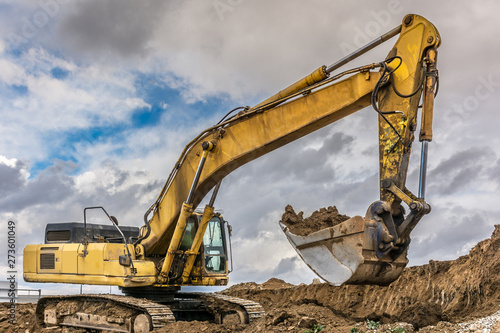 An excavator extracting dirt in a construction site