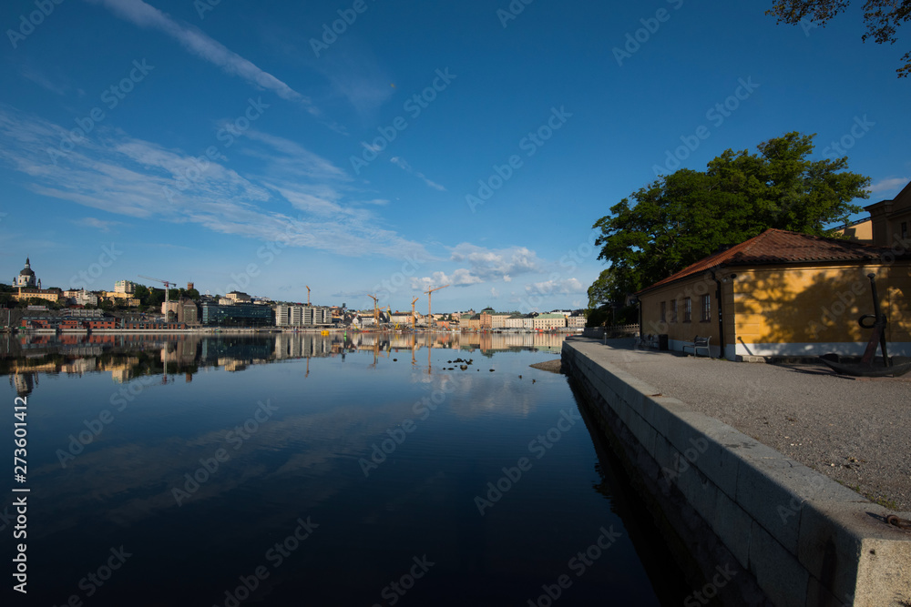 Boats, pier and landmarks in Stockholm a tranquil morning, 