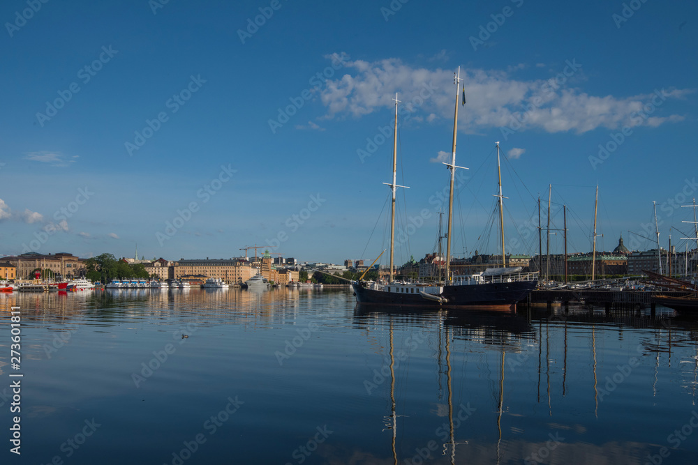 Boats, pier and landmarks in Stockholm a tranquil morning, 
