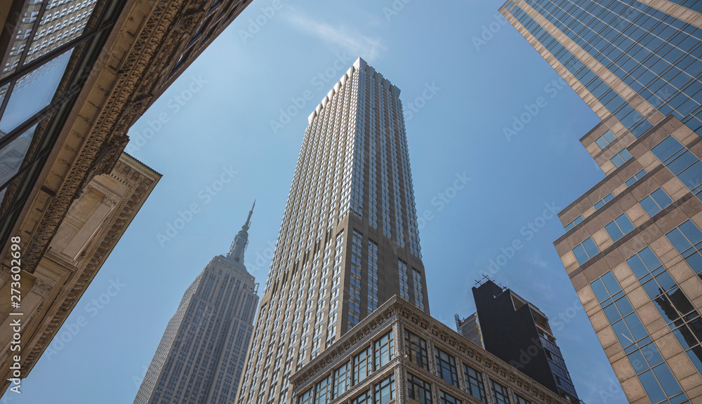 New York, Manhattan. High buildings view from below against blue sky background
