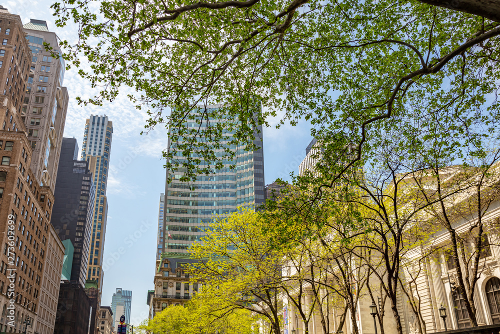 Obraz premium New York, Manhattan. High buildings view from below against blue sky background, sunny day in spring