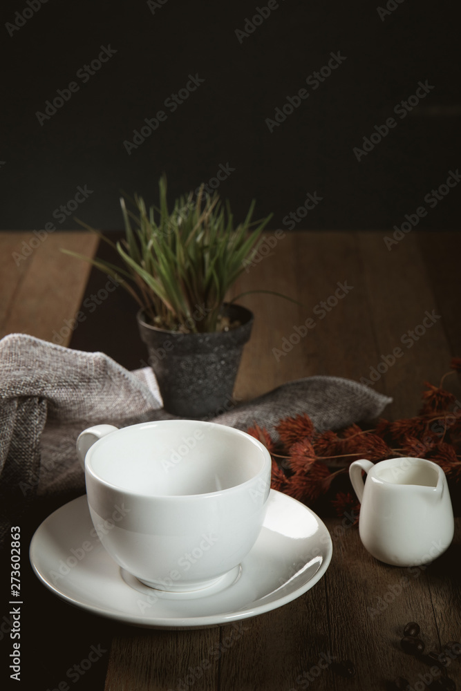 Empty cup of coffee decoration with coffee bean low light mood and tone on wooden table background Empty cup of coffee decoration with coffee bean low light mood and tone on wooden table background