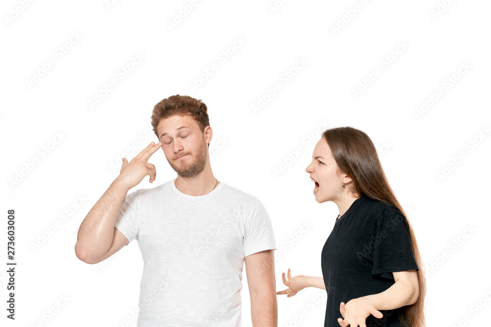 Studio shot of a couple quarreling. Angry woman shouting at the partner Studio shot of a couple quarreling. Angry woman shouting at the partner