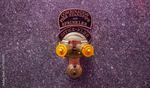 Fotografie Fire standpipe outdoors on an office building facade, New York, Manhattan