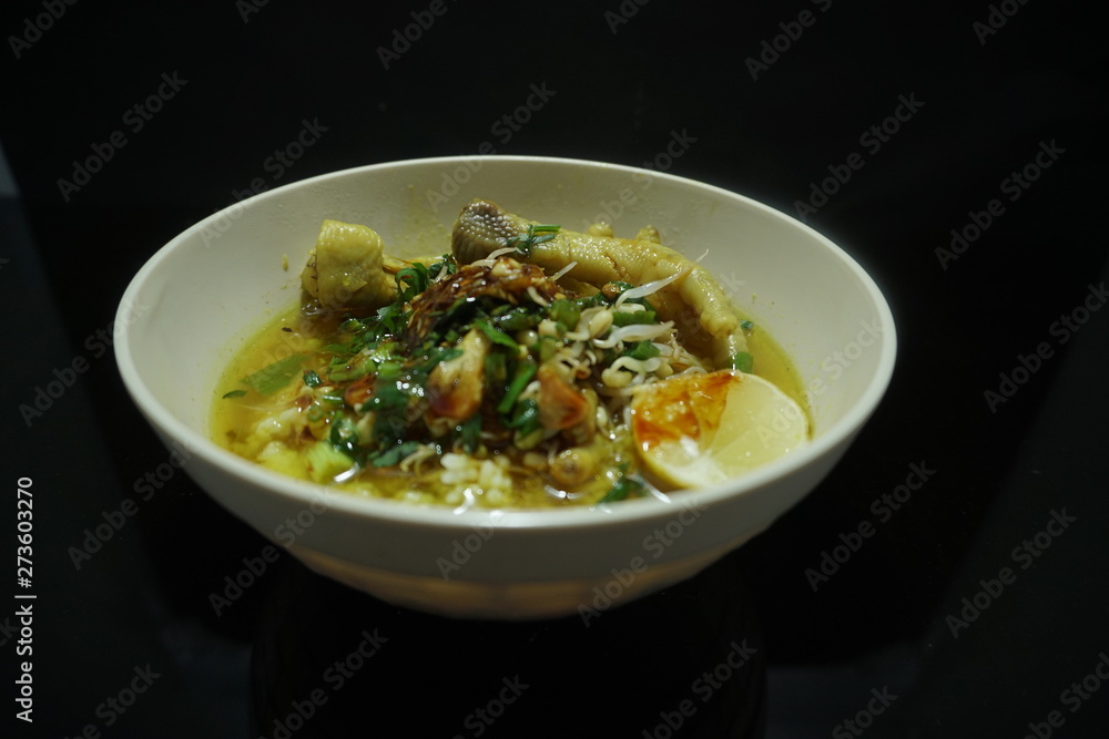 chicken porridge on a white bowl isolated on black background chicken porridge on a white bowl isolated on black background