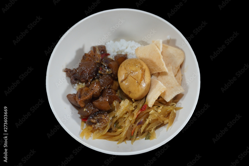 Indonesian food.Rice with side dishes of kikil, eggs and crackers.Delicious food Indonesian food.Rice with side dishes of kikil, eggs and crackers.Delicious food