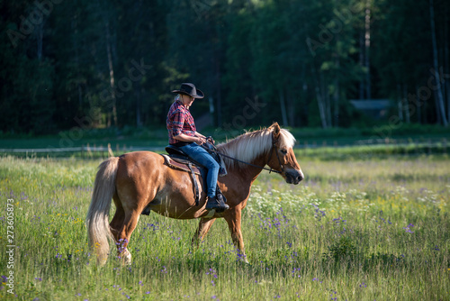 Cowgirl horseback riding