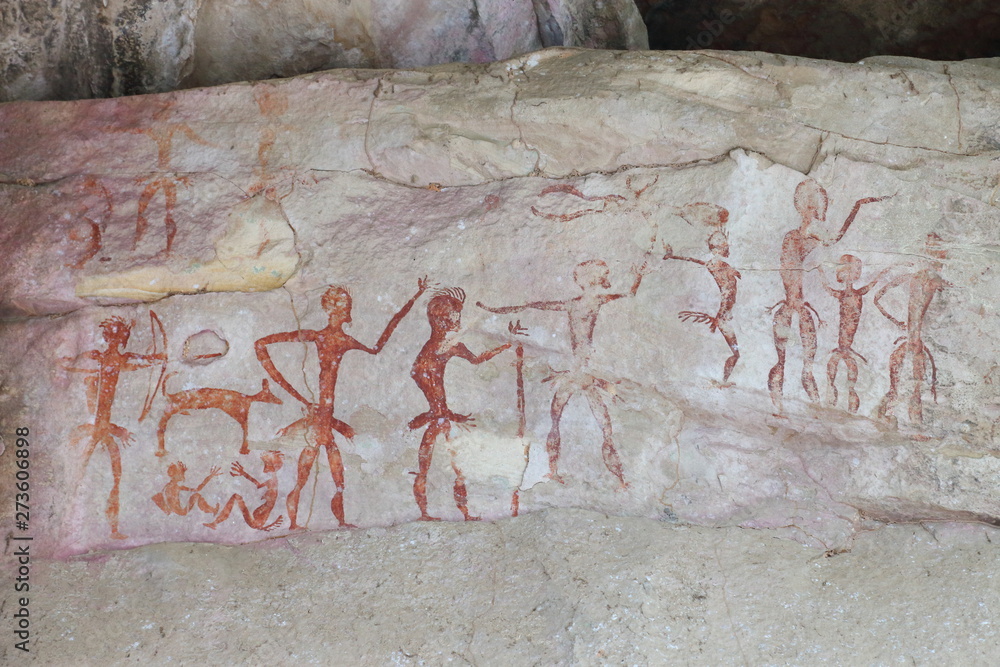Prehistoric painting by primitive local caveman on the stone wall showing the hunting and civilization over 4000 years, Thailand