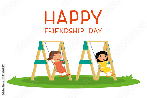 Happy friendship day. Two cute little girls swinging on swing in public park or kindergarten playground. Place for games. Happy school or preschool kids friends playing together outside.