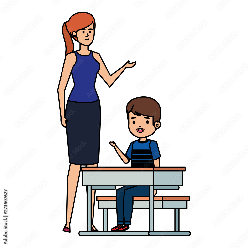 student boy seated in school desk with female teacher student boy seated in school desk with female teacher