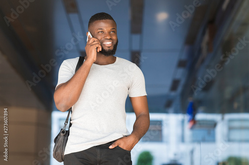 Successful african american guy talking on cellphone