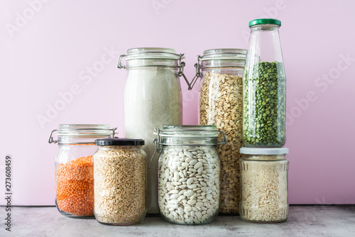 Variety of grains and legumes in glass jars. Zero waste storage concept