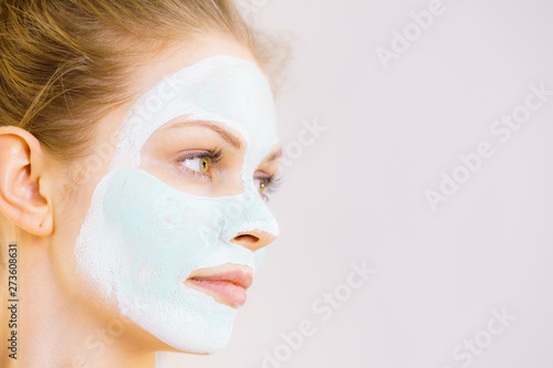 Girl with white green mud mask on face