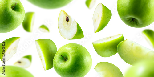 A group of green apples levitating on a white background photo