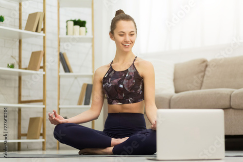 Online Yoga. Woman Training And Meditating With Laptop