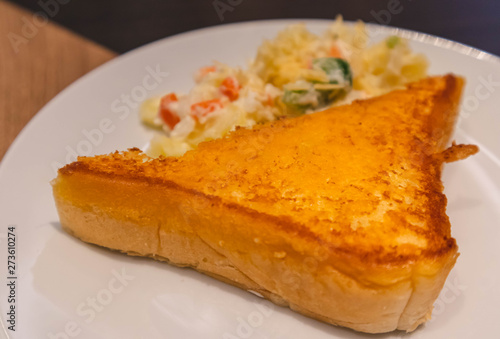 Crispy and tasty yellow bread french toast with mashed potato on white ceramic plate