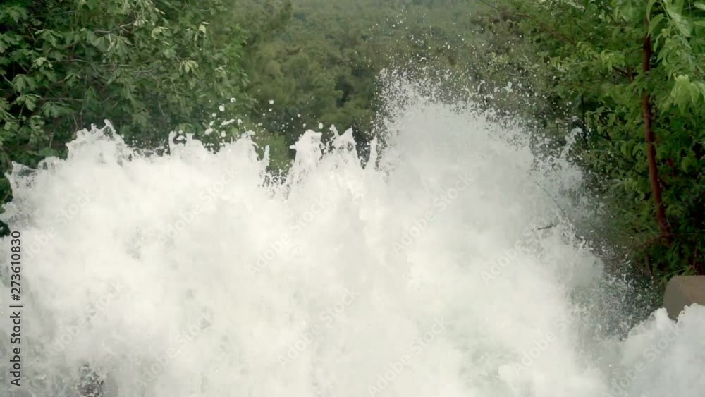 Close-up shows the spray rising up in front of the waterfall Close-up shows the spray rising up in front of the waterfall