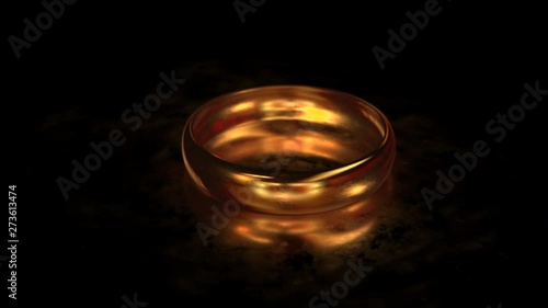 Flying around the gold ring on the matte glass surface with reflection