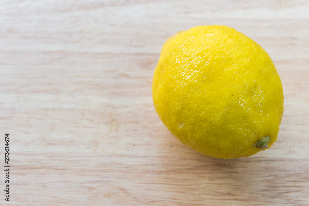 Fresh lemons on wooden background.  Top view with copy space