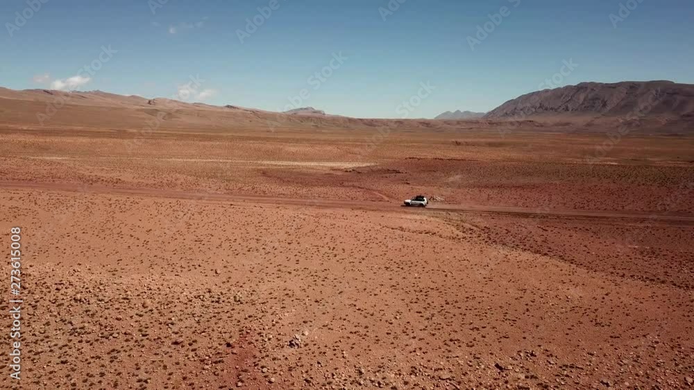 Drone view of an off-road vehicle driving in Morocco desert Drone view of an off-road vehicle driving in Morocco desert