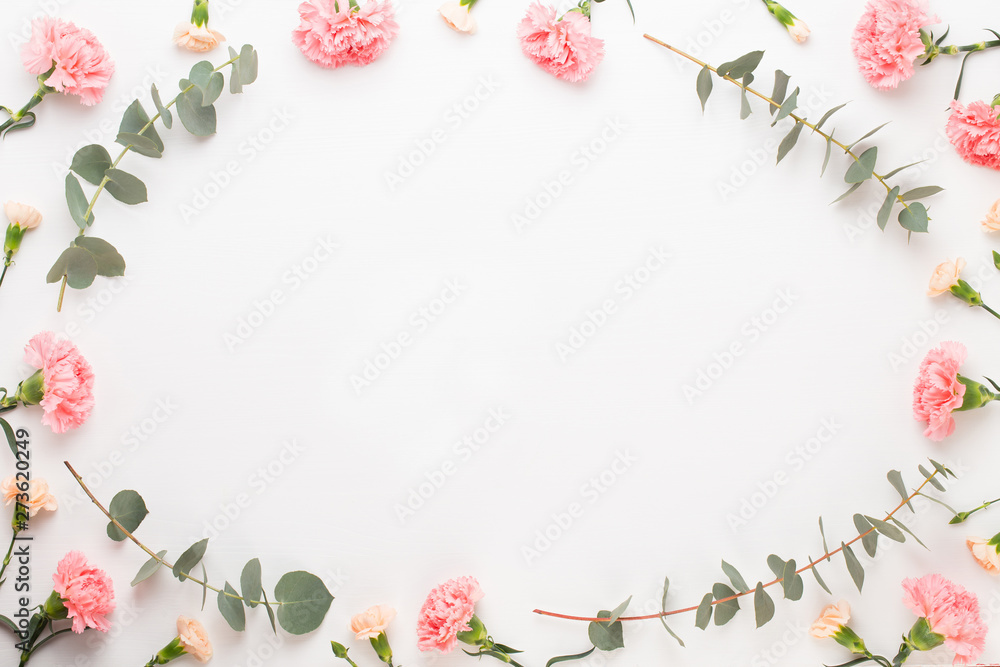 Fototapeta Flowers and eucaaliptus composition. Pattern made of various colorful flowers on white background. Flat lay stiil life.