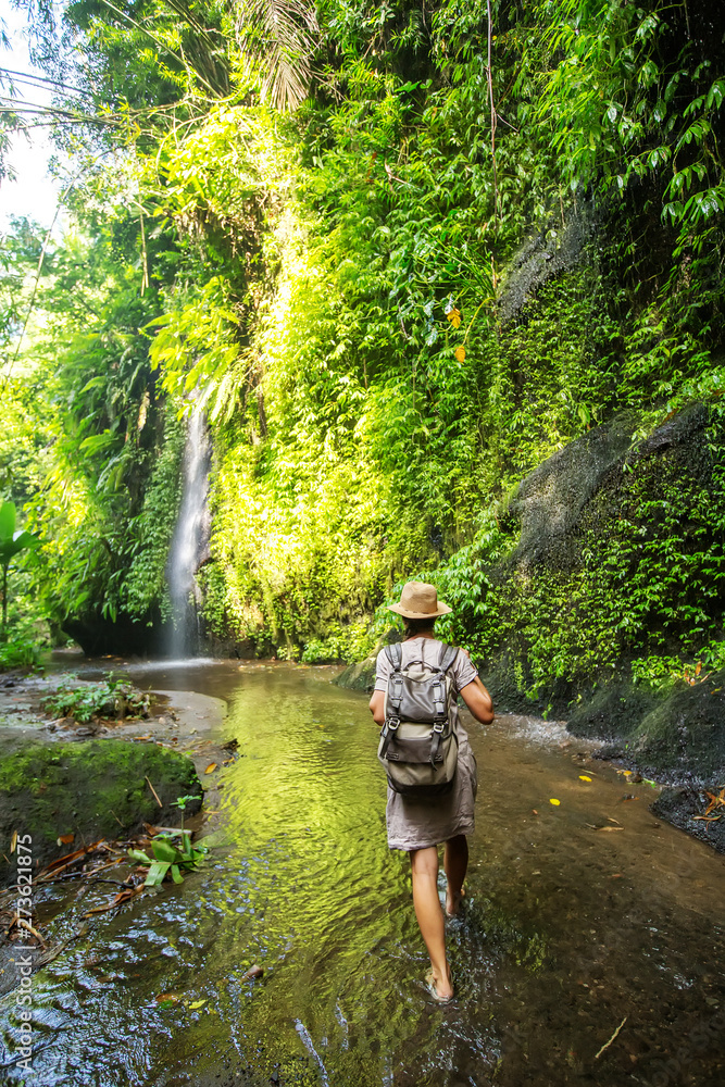 Obraz premium Woman near waterfal on Bali, Indonesia&nbsp;