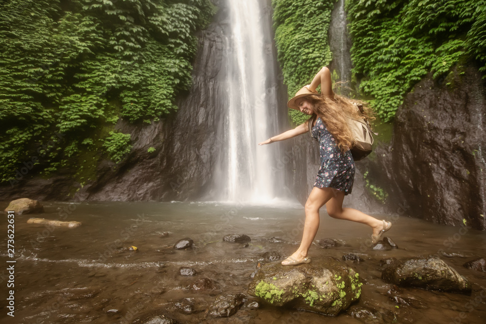 Woman near Munduk waterfal on Bali, Indonesia Woman near Munduk waterfal on Bali, Indonesia