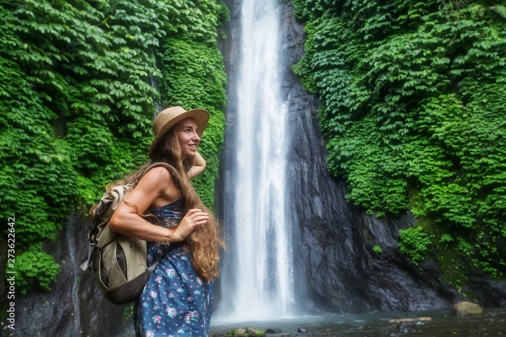 Woman near Munduk waterfal on Bali, Indonesia Woman near Munduk waterfal on Bali, Indonesia