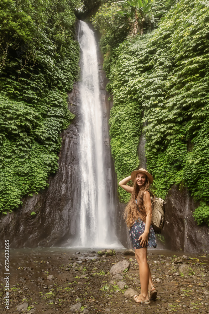 Woman near Munduk waterfal on Bali, Indonesia Woman near Munduk waterfal on Bali, Indonesia