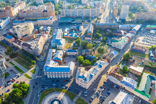 Aerial view of old European city center or downtown, modern and historic buildings, factories and car traffic in sunny summer day