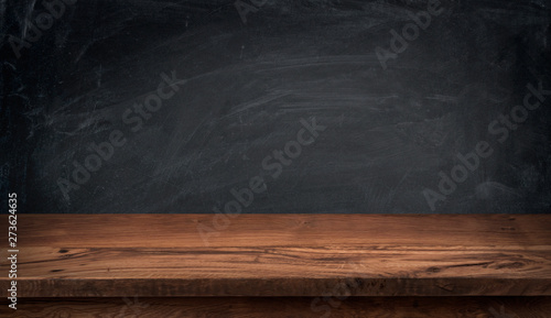 Empty wooden texture table for product display on chalkboard background