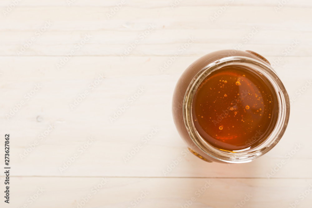Top view glass jar full of honey Top view glass jar full of honey