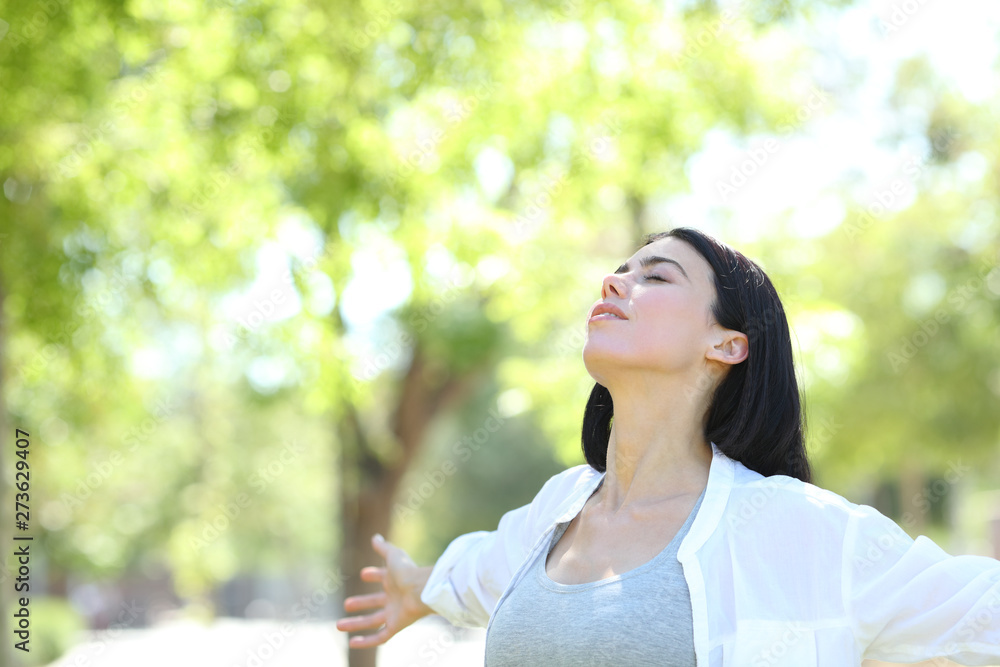 Woman relaxing in a park breathing fresh air Woman relaxing in a park breathing fresh air