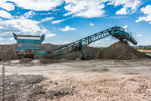 Recycling plant. Transforming asphalt from a gravel road to the construction of a new highway
