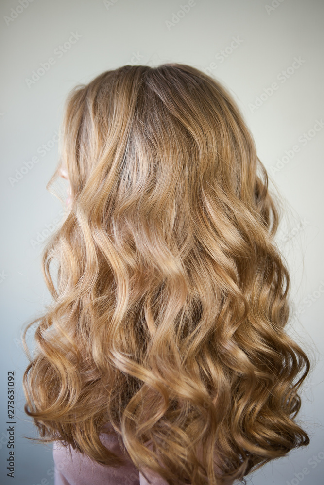 Naklejka premium blond with perfect curls, long hair with curls,