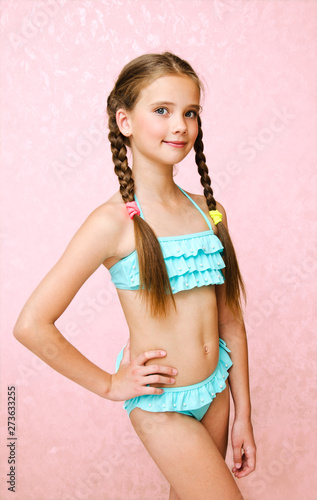 Photography Portrait of cute smiling little girl child schoolgirl teenager in swimsuit isola