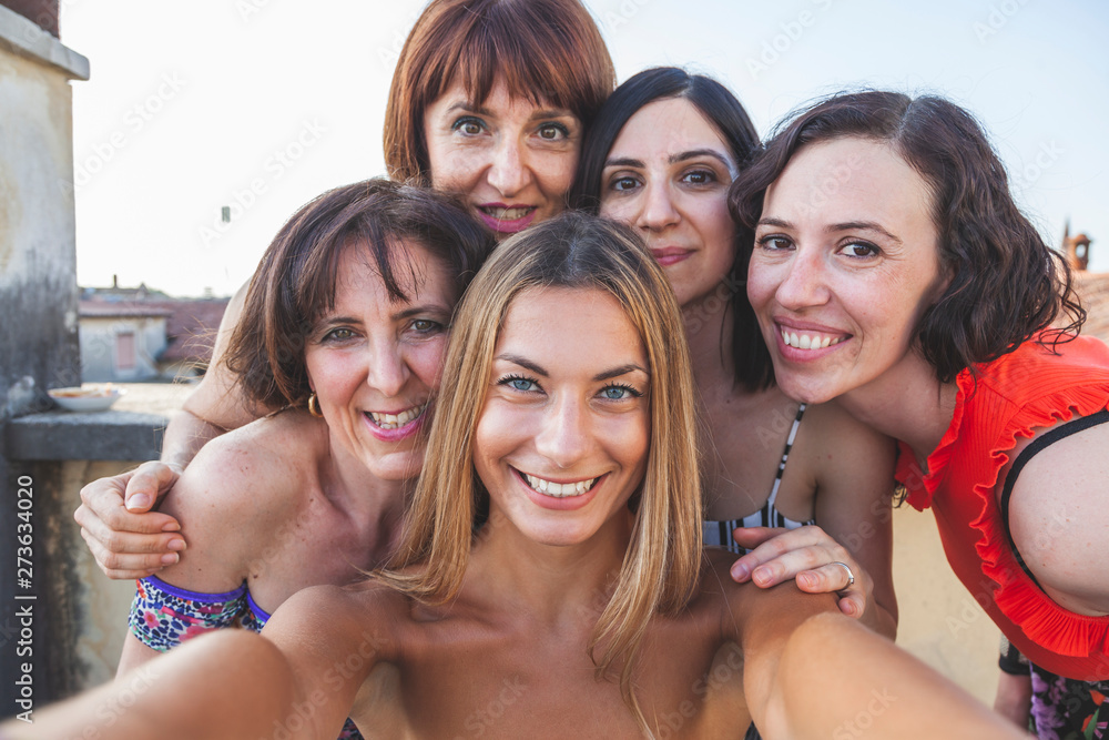 group of female friends taking a selfie with smarthphone group of female friends taking a selfie with smarthphone