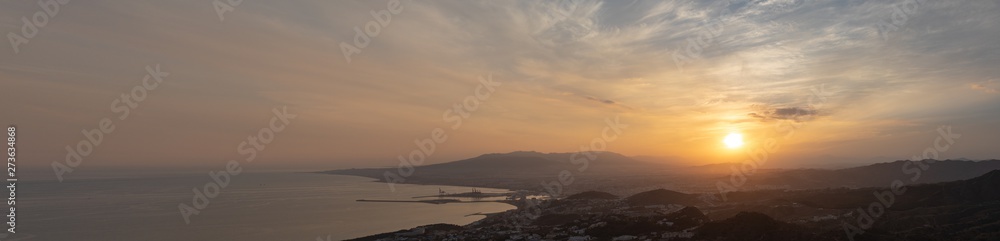 the panorama skyline of malaga in Andalusia, Spain at sunset