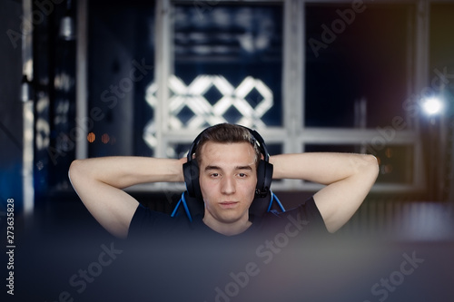 Young  gamer playing online video games on computer and satisfied after won his last and the hardest battle   