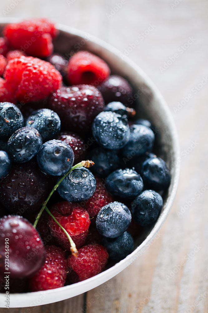 fresh berries covered by water drops in a bowl fresh berries covered by water drops in a bowl