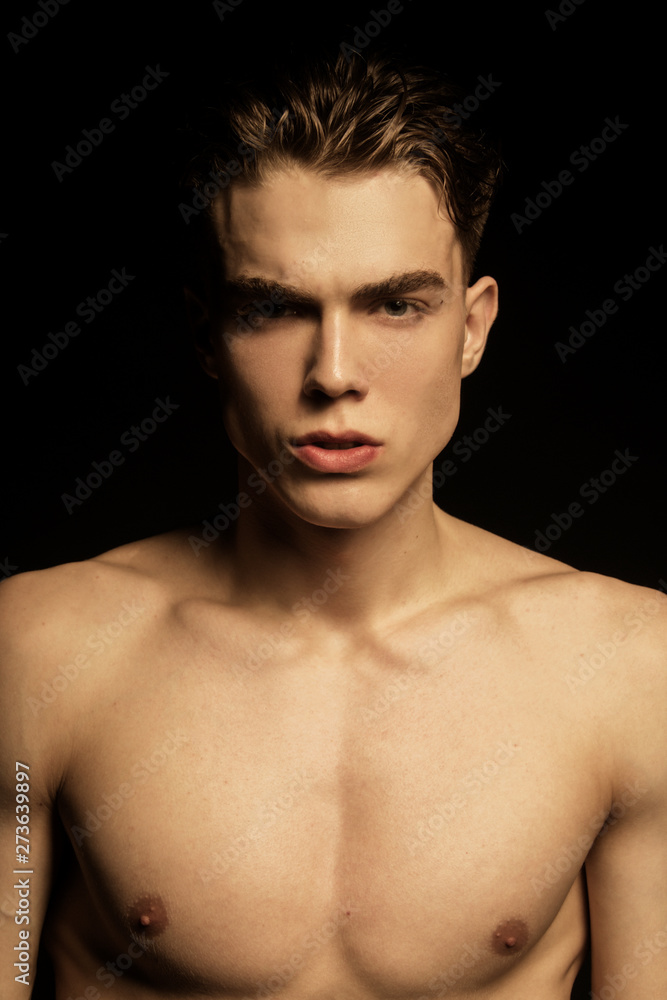 Muscle strong beautiful stripped male model portrait on black isolated font background Muscle strong beautiful stripped male model portrait on black isolated font background