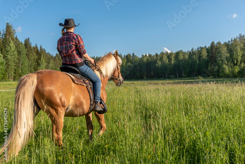 Fotografie Woman horseback riding