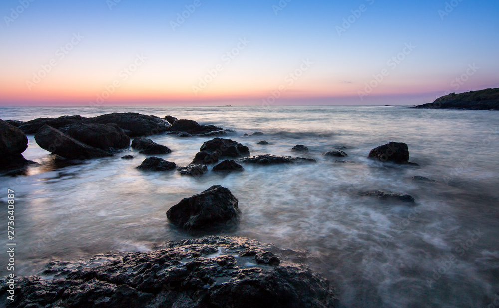 Fototapeta premium sunrise over the sea coast with rocks