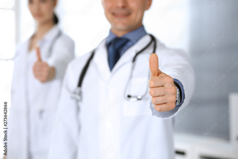 Group of doctors showing thumbs up. Perfect medical service in clinic. Happy future in medicine and healthcare concept Group of doctors showing thumbs up. Perfect medical service in clinic. Happy future in medicine and healthcare concept