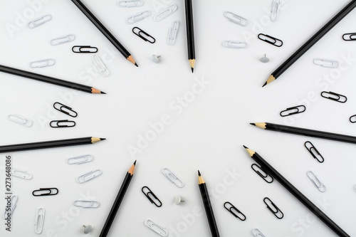 Wallpaper Mural Black pencils and paper clips, white buttons and paper clips lie on a white background. Torontodigital.ca