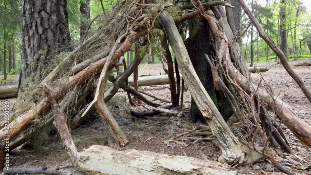 Cozy manmade shelter with wooden sticks and branches. Going inside. 4k slowmotion. Cozy manmade shelter with wooden sticks and branches. Going inside. 4k slowmotion.